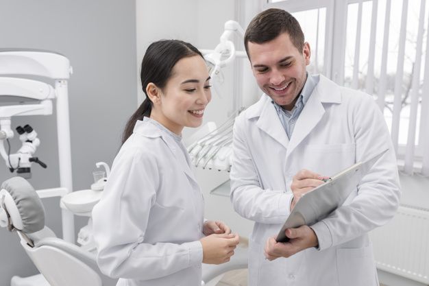 Mockup photo — male and female dentist reviewing a chart